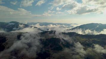 Flying above the clouds in the Carpathian Mountains. Beautiful landscape. 4K video
