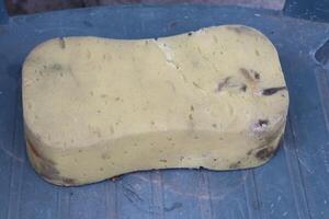 A Natural Sponge Sitting on a Blue Surface, Ideal for Cleaning and Daily Bathing Needs photo
