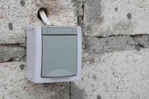 WallMounted Electrical Outlet Installed on Solid Concrete Surface for Convenient Usage photo