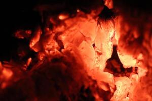 Glowing Ember Rocks Reside in a Dark Background That Highlights Their Beauty and Brightness photo