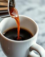 Freshly brewed coffee being poured into a white cup on a marble surface in a cozy cafe setting photo