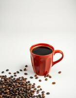 Coffee in a red cup surrounded by scattered coffee beans on a plain background photo