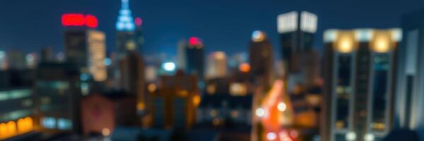City skyline illuminated by lights during nighttime with a focus on blurred skyscrapers photo