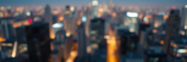 City skyline illuminated at night showcases vibrant lights and tall buildings under a deep blue sky photo