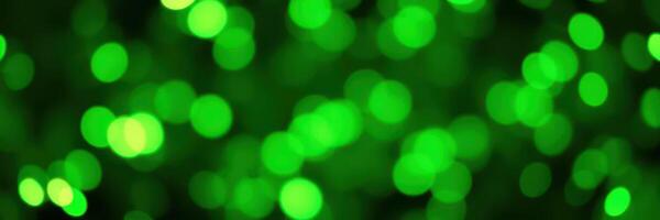 Vibrant green bokeh lights create a festive atmosphere at an evening event in a city park photo