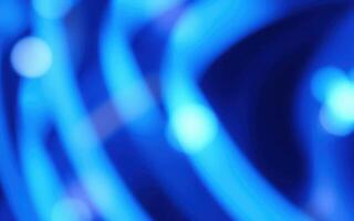Vibrant blue abstract patterns created by glowing lights during a night event in an urban setting photo
