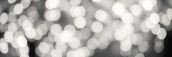 Soft bokeh lights create a dreamy atmosphere during an evening gathering in an outdoor setting photo