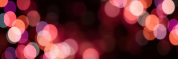 Colorful bokeh lights create a vibrant atmosphere during an evening celebration in a festive setting photo