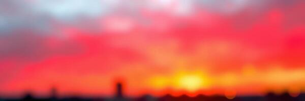 Vibrant sunset with blurred horizon over city skyline creating a dreamy atmosphere during twilight photo