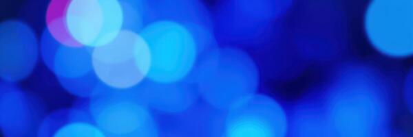 Vibrant blue bokeh lights illuminating a festive atmosphere at a nighttime event photo