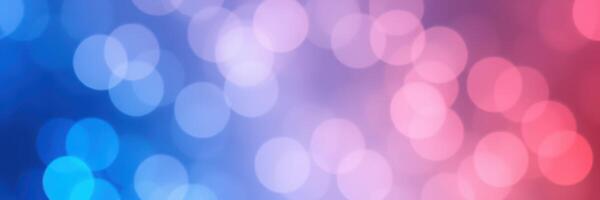 Colorful bokeh background featuring hues of blue, pink, and purple created by soft lighting and blurred circles photo