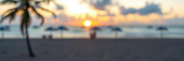 Sunset over the beach with silhouettes of palm trees and people enjoying the view in the background photo