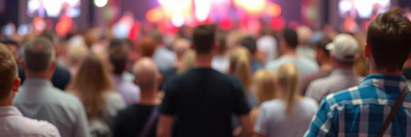 Crowd engaging in lively event with colorful lights and performances at a large venue photo