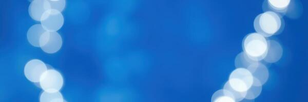 Soft blue background with glowing circular lights creating a dreamy atmosphere at a festive event in the evening photo