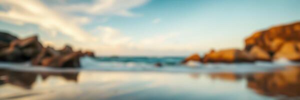 Beautiful beach landscape with gentle waves and rocky formations during sunset near coastline photo