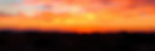 Vibrant sunset over a tranquil landscape, casting warm hues in the evening sky photo
