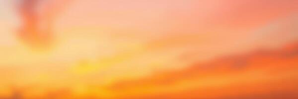 Colorful sunset over the horizon with soft clouds reflecting warm hues in the evening sky photo