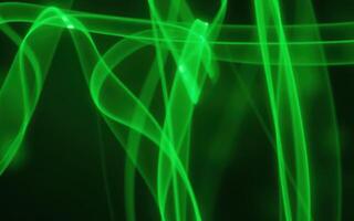 Swirling green patterns create an abstract visual effect against a dark background in this vibrant display of light and color photo