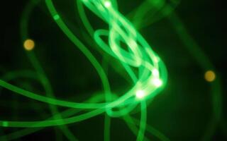 Colorful abstract light trails swirl and dance against a dark background photo