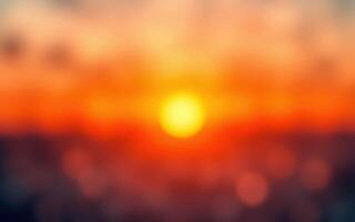 Vibrant sunset casting warm hues over the horizon with blurred clouds creating a serene atmosphere photo