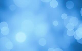 Soft blue background with blurred bokeh lights creating a serene atmosphere for various design projects photo