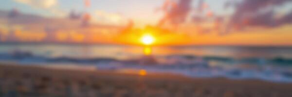 Sunset over the ocean with warm colors illuminating the sky and reflecting on the water during a tranquil evening at the beach photo