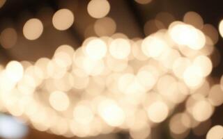 Soft, glowing lights create a warm ambiance in a bustling cafe during the evening hours photo
