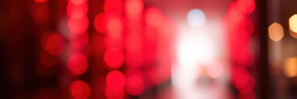 Vibrant red bokeh lights create a dreamy atmosphere in a lively urban setting during evening hours photo