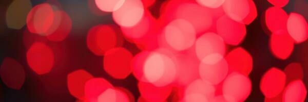 Vibrant red bokeh lights create a festive atmosphere at a celebration event on a winter evening photo