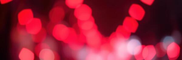 Vibrant red bokeh lights create a festive atmosphere during the celebration in a dynamic city setting at night photo