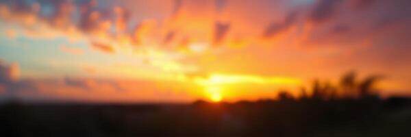 Vibrant sunset over a serene landscape with colorful clouds near the horizon photo