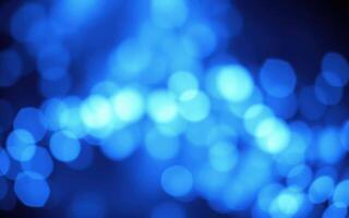 Colorful blue bokeh lights create a mesmerizing visual effect in an abstract setting during a festive evening photo