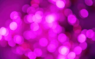 Colorful pink bokeh lights create a vibrant atmosphere for a festive celebration photo