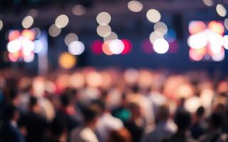 Crowd gathers at an indoor event with bright lights and lively atmosphere during the evening photo