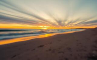 Vibrant sunset over a tranquil beach with waves gently crashing at dusk photo