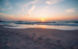 Beautiful sunset at the beach with gentle waves lapping the shore on a serene evening photo