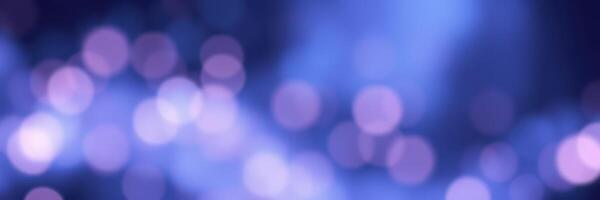 Soft purple and blue bokeh lights create a dreamy atmosphere during a nighttime celebration in an urban setting photo