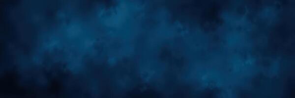 Night sky filled with swirling clouds and a deep blue backdrop creating a dramatic atmospheric effect photo