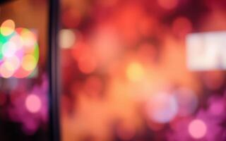 Colorful bokeh lights create a vibrant atmosphere in an urban setting at night during a lively celebration photo