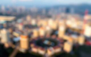 Urban landscape view during golden hour with blurred city skyline and structures in the background photo