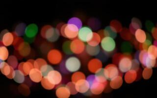 Vibrant bokeh lights create a festive atmosphere during a nighttime celebration in a city park photo