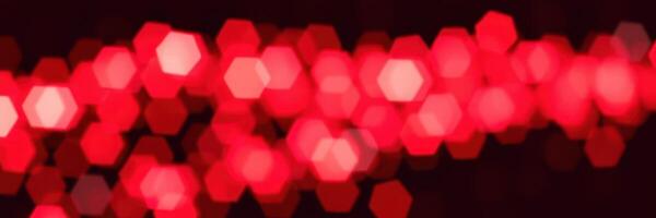 Vibrant red hexagonal lights create a dazzling ambiance at an evening celebration photo