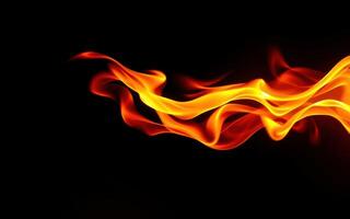 Flames dance gracefully in the darkness creating a striking visual display of fire and warmth photo