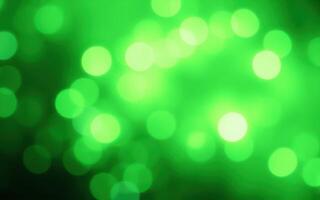 Vibrant green bokeh effect creating a magical atmosphere in a dimly lit space during a nighttime event photo