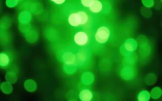 Colorful green bokeh lights create a whimsical atmosphere in a festive celebration at night in a city park photo
