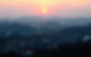 Sunset casts soft hues over distant hills, creating a tranquil atmosphere in the evening sky photo