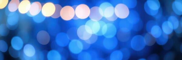Soft blue bokeh lights create a calming atmosphere at night during a festive event in an urban setting photo