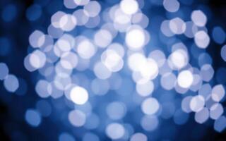 Soft blue bokeh lights create a calming atmosphere, illuminating a dark background and enhancing visual appeal for evening settings photo