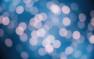 Brightly lit abstract background with blurred bokeh effect against a tranquil blue backdrop creating a dreamy atmosphere photo