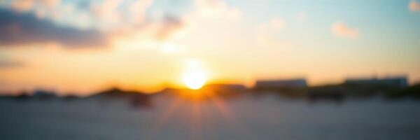 Sunset over the horizon with soft colors illuminating the evening sky near the beach photo